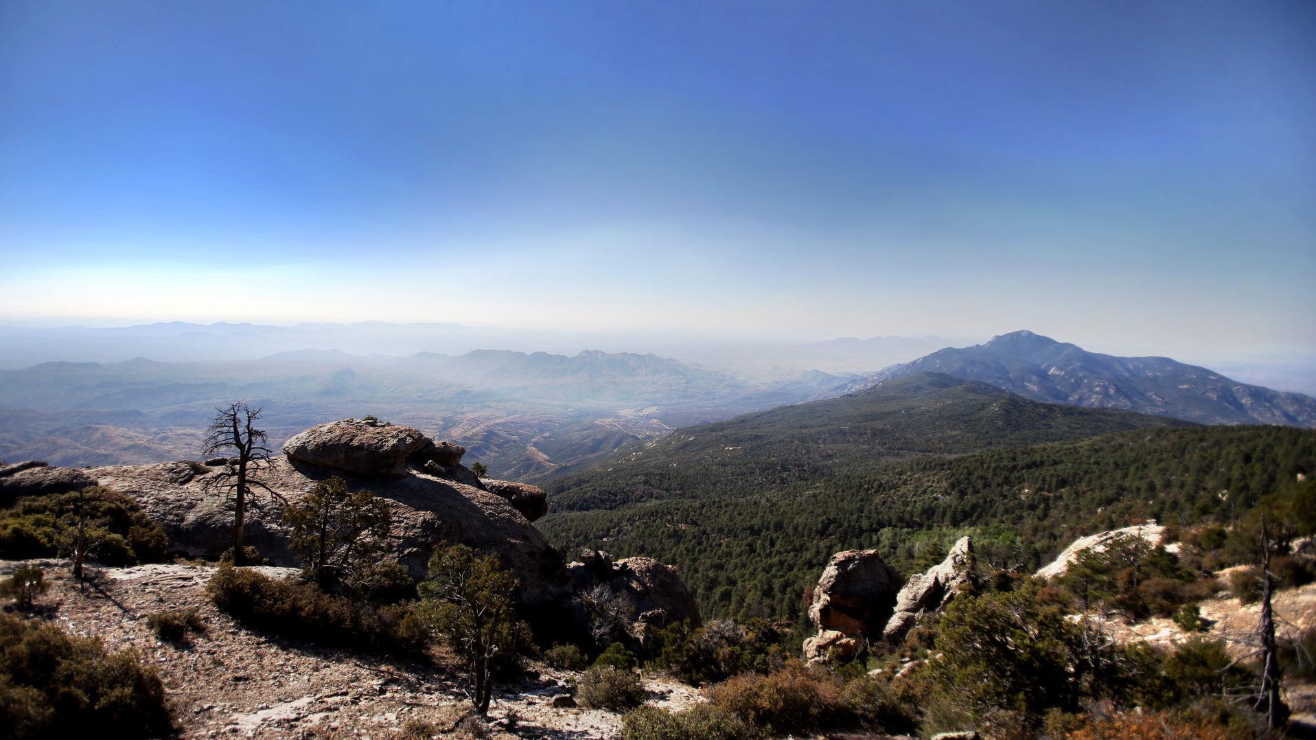 You might see smoke billowing off the Rincon Mountains in October
